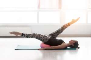 Woman,Doing,Pilates,With,A,Small,Ball,On,The,Floor Woman,doing,pilates,with,a,small,ball,on,the,floor